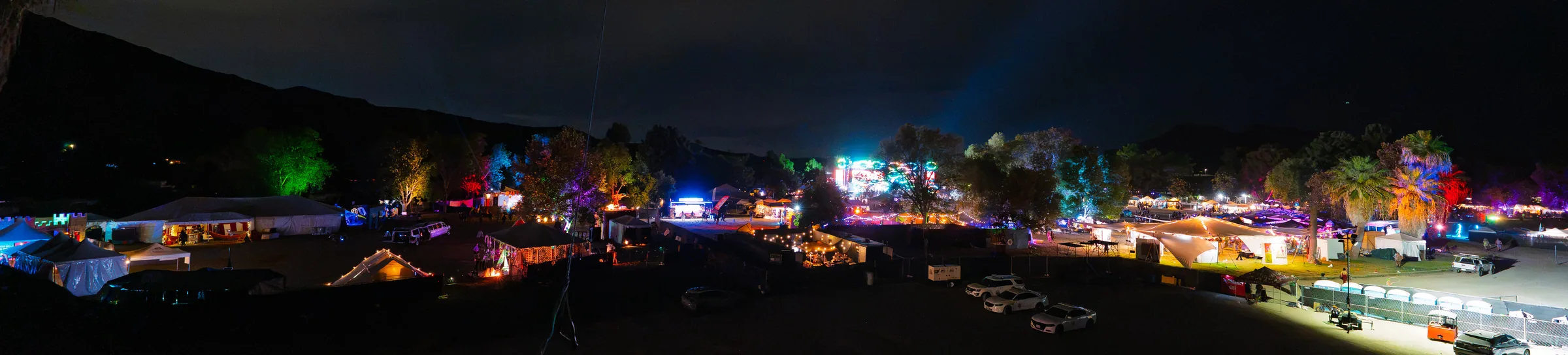 A wide panorama of the illuminated festival grounds